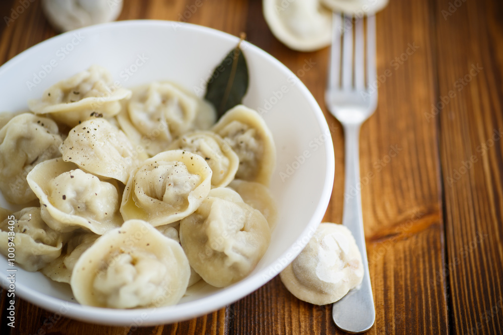 boiled dumplings with meat in a white plate boiled dumplings with meat in a white plate