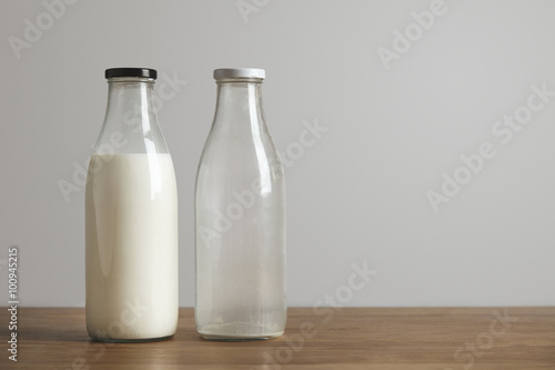 Simple vintage bottles with fresh milk and empty