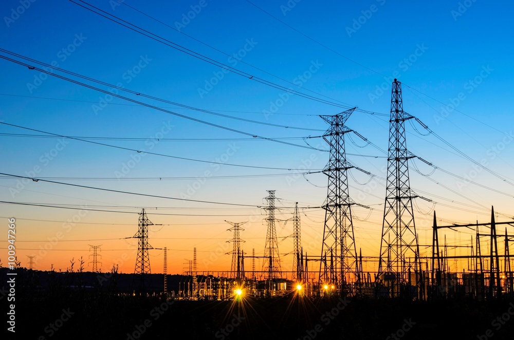 Fototapeta premium Electric powerlines over sunrise