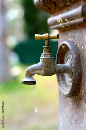Old Brass faucet with drop of water