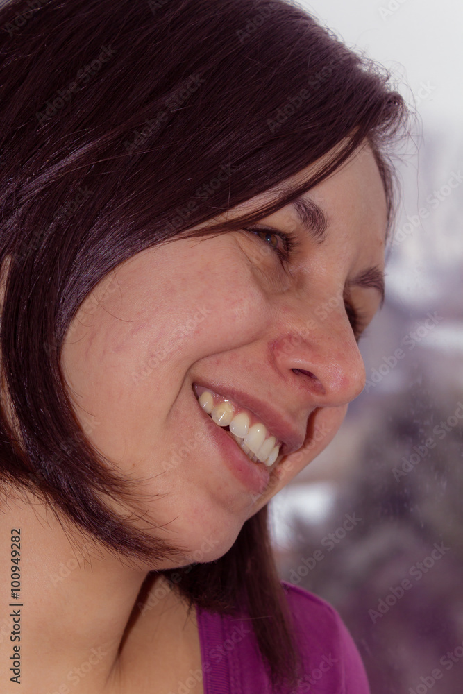 Portrait of a smiling young woman by the window Portrait of a smiling young woman by the window