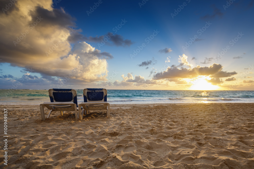 Sunrise, beach chairs on the tropical carribean beach.