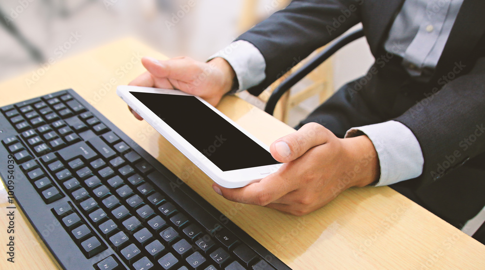 Businessman using tablet and computer. Businessman using tablet and computer.
