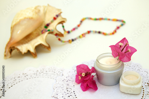 Jars of Cream and sea shell on background photo