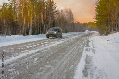 car in the road  winter at dawn