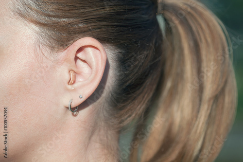 woman with a hearing aid, hearing amplifier