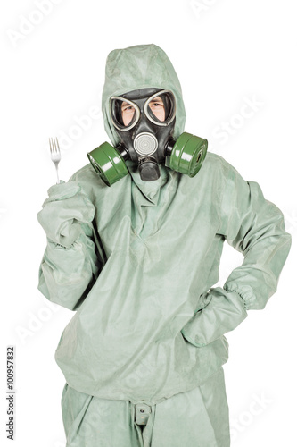 Man with protective mask and protective clothes shows a fork for