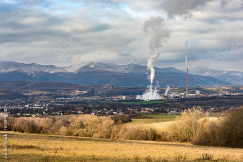 Powerplant in Slovakia seen in distance surrounded by nature and small town. Symbol of Technology, pollution and urbanism