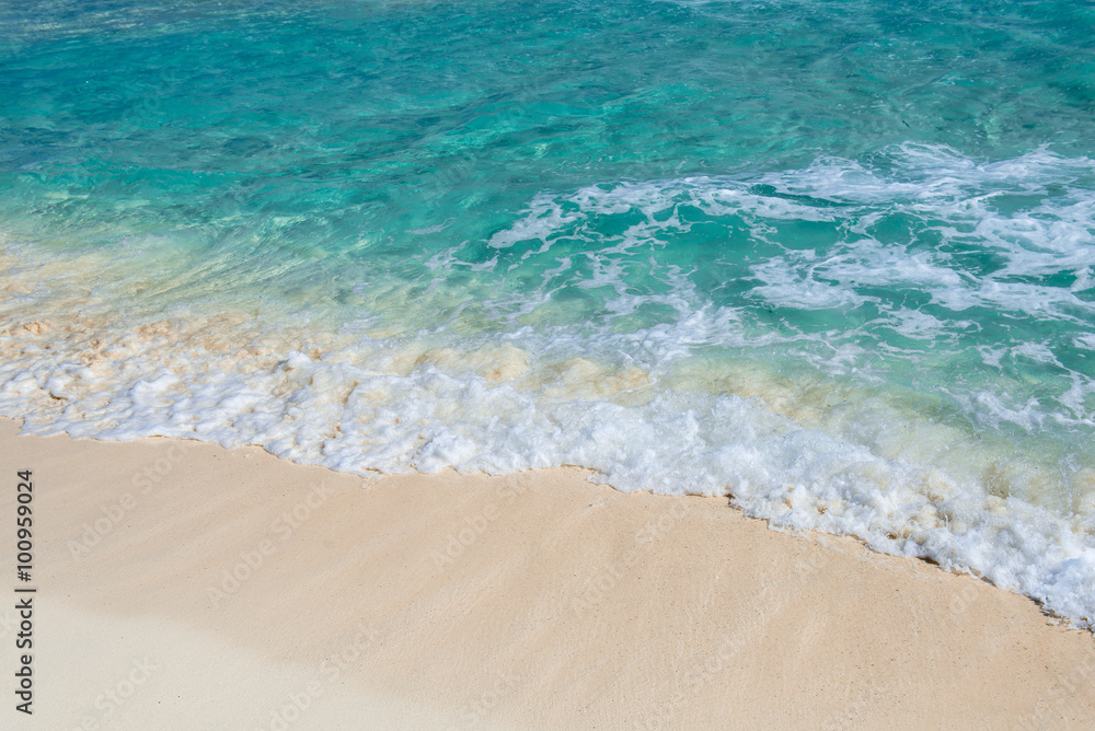 Soft wave of the turquoise sea on the sandy beach. Natural summe