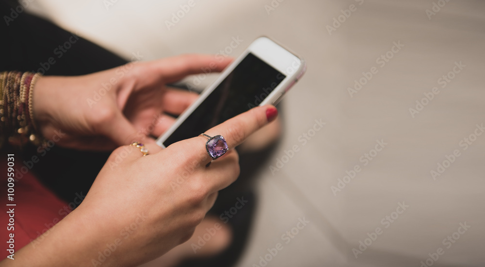 Hands of a woman texting on her mobile phone Hands of a woman texting on her mobile phone