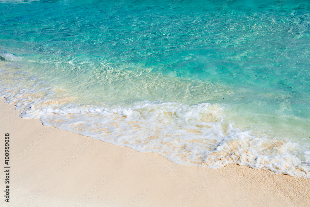 Soft wave of the turquoise sea on the sandy beach. Natural summe