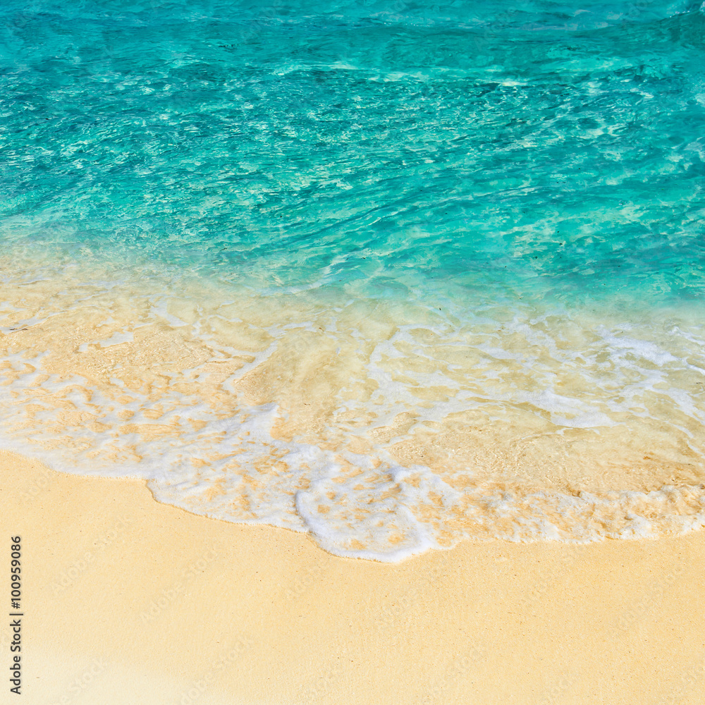 Soft wave of the turquoise sea on the sandy beach. Natural summe