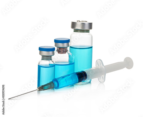 Sterile medical vials with blue medication solution, ampoules, and syringe isolated on a white background.