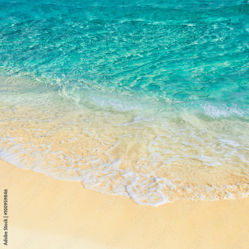 Soft wave of the turquoise sea on the sandy beach. Natural summe