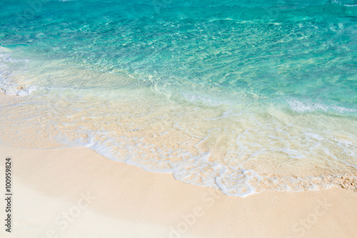 Soft wave of the turquoise sea on the sandy beach. Natural summe © bobiphil