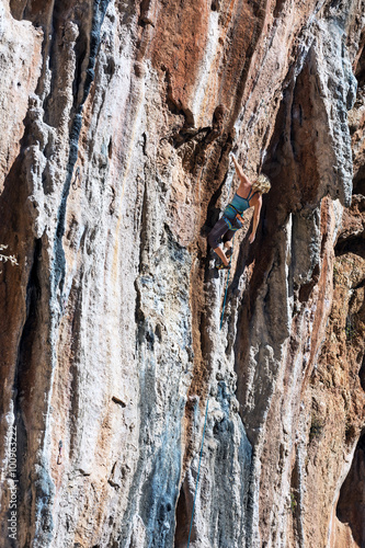 Female Mountain Climber lead climbing natural Rock
