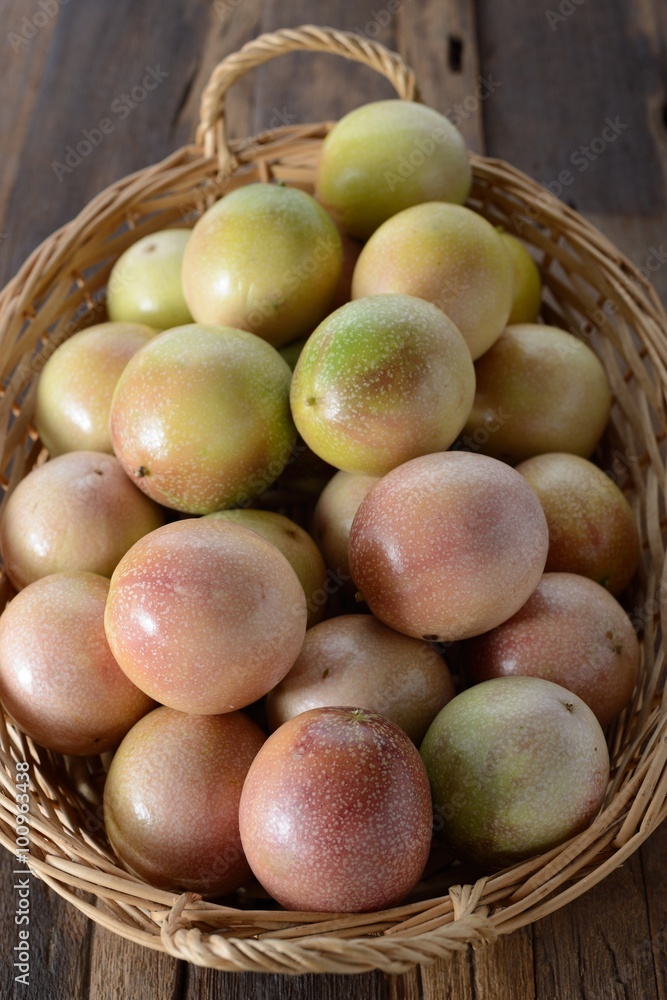 passion Fruits in the bamboo baskets on the wooden background. passion Fruits in the bamboo baskets on the wooden background.