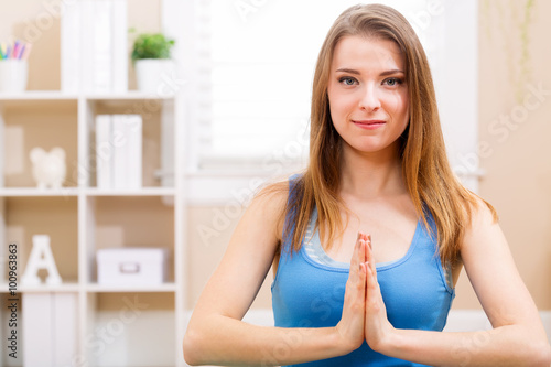 Free Download Happy young woman meditating at home - GFXLoad