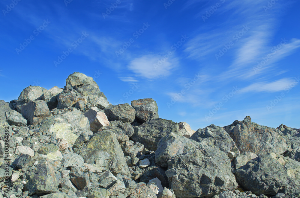 A heap of stones on a background of blue sky