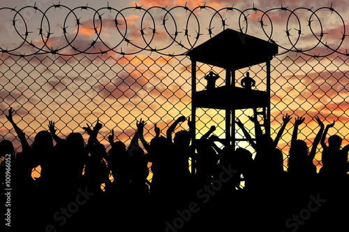 Silhouette of a crowd of refugees photo