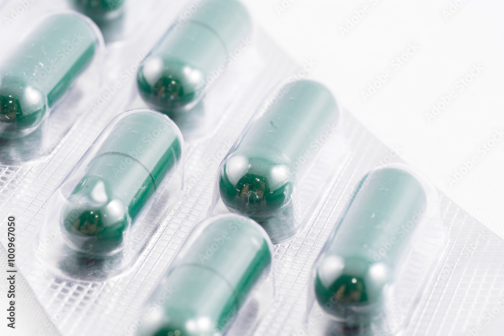 Green capsule medication box on a white background Green capsule medication box on a white background