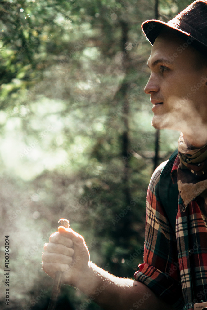 stylish hipster traveler exploring in sunny forest in the mounta stylish hipster traveler exploring in sunny forest in the mounta