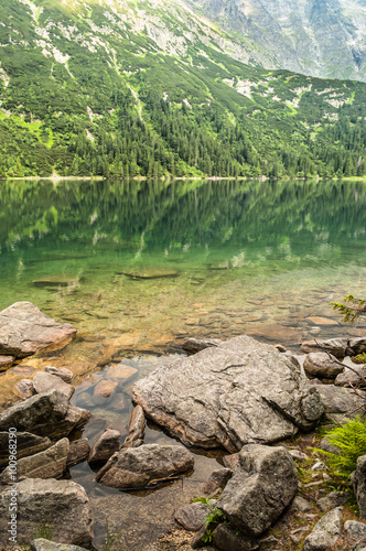 Landscape of mountain lake shore with clear water in the mountain
