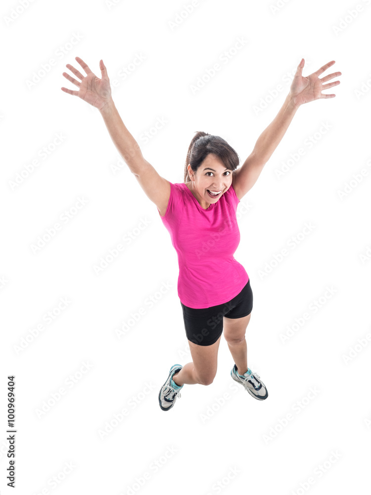 Photograph of young mixed race female in bright workout wear jumping for joy. Photograph of young mixed race female in bright workout wear jumping for joy.