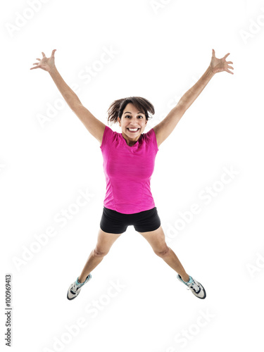 Photograph of young mixed race female in bright workout wear jumping for joy.
