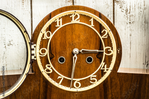 Old vintage clock on wooden background. Time concept.