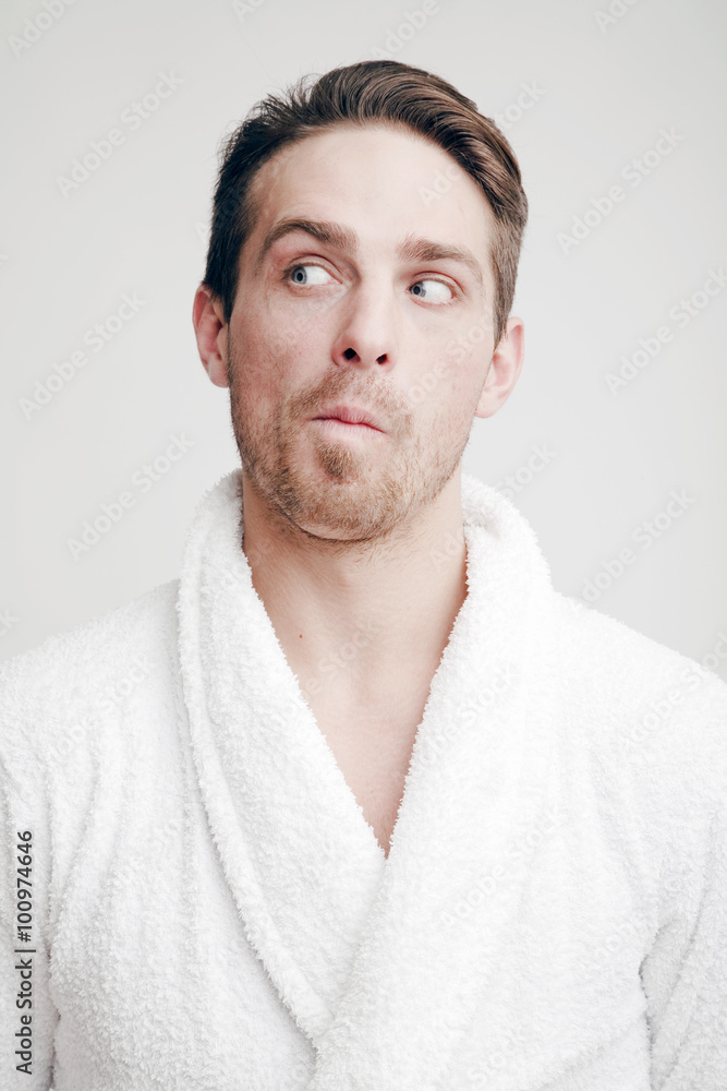 Obraz premium Emotions. Portrait of a Man with a puzzled face in bathrobe
