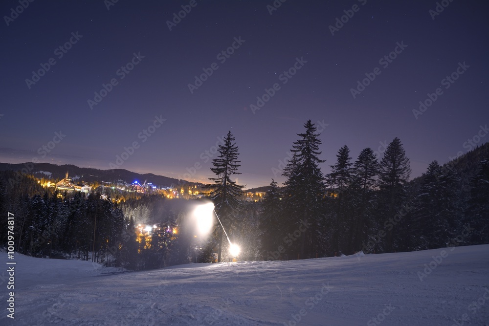 Ski slope in Poiana Brasov winter resort, Romania. Dark scenery. Night long exposure.