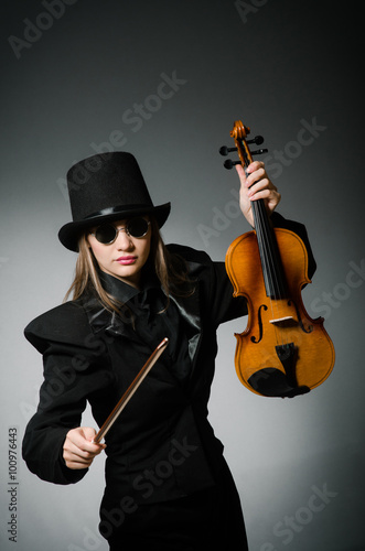 Woman playing classical violin in music concept