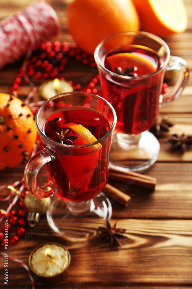 Mulled wine in glass on brown wooden table Mulled wine in glass on brown wooden table