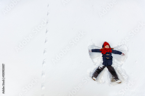 Child girl playing in snow