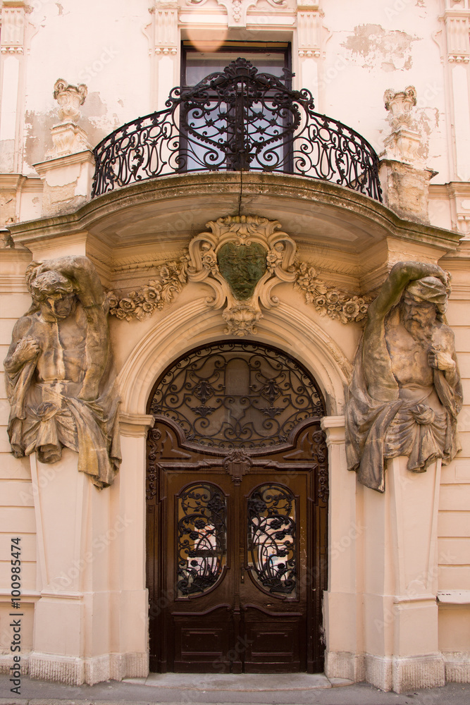Beautiful baroque style entrance with an iron balcony and arch