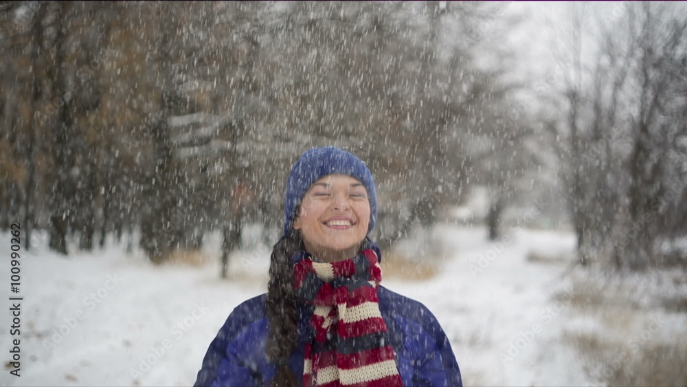 Young cheerful woman throwing up snow Young cheerful woman throwing up snow