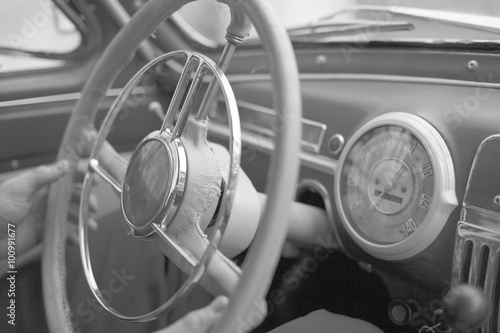 Steering wheel and a dashboard in the interior of an old stylish retro car