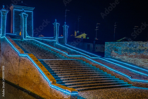 ancient bridge at night lit by Christmas lights photo