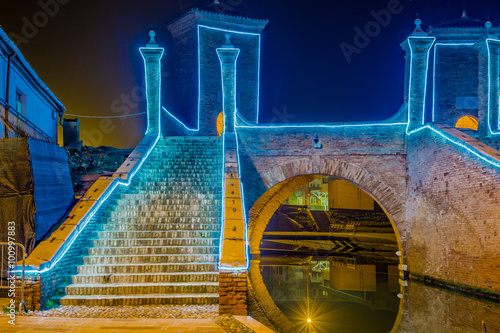 ancient bridge at night lit by Christmas lights photo