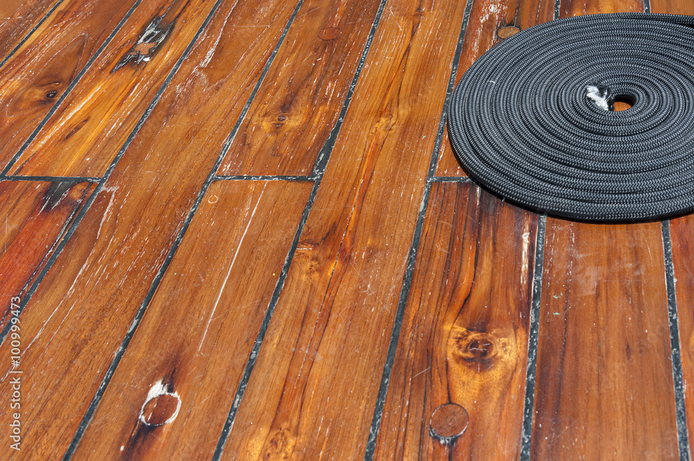 Fototapeta premium Rope on wooden deck of ship