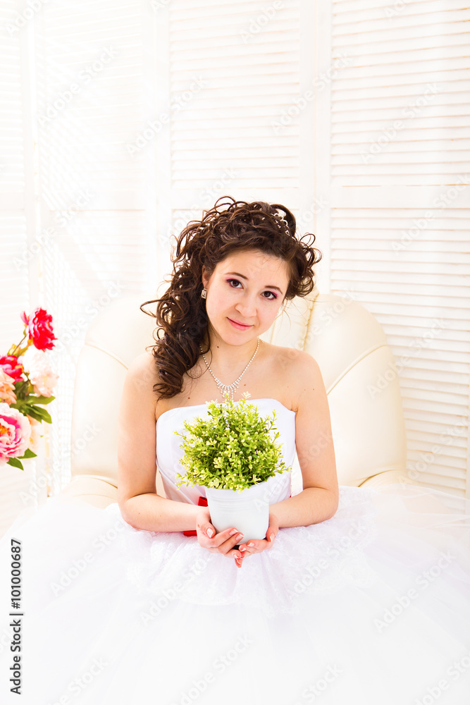 Attractive woman holding pot with beautiful green herb Attractive woman holding pot with beautiful green herb