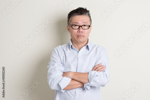 Portrait of mature Asian male people arms crossed