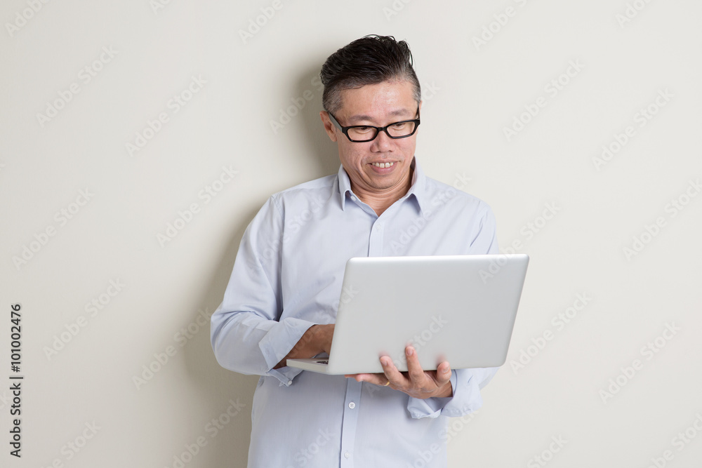 Mature Asian man and IT concept Mature Asian man and IT concept
