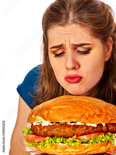 Girl holding big hamburger and wants to eat it . Fastfood concept.