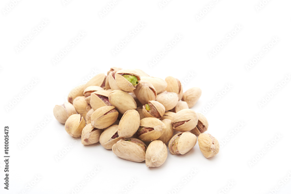 Heap of pistachios nuts isolated on the white Heap of pistachios nuts isolated on the white