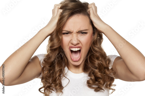 angry and mad pretty girl on a white background