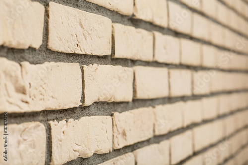 Beige brick wall in perspective