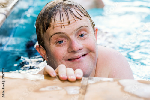 Portrait of handicapped boy in swimming pool.