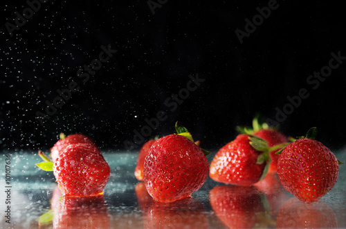 strawberries under water drops